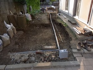 Fixing the downpipes before starting on the driveway